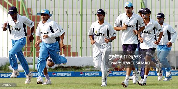 Indian cricket team members jog during a practice session at the Arbab Niaz Stadium in Peshawar, 18 March 2004. The third One Day International match...