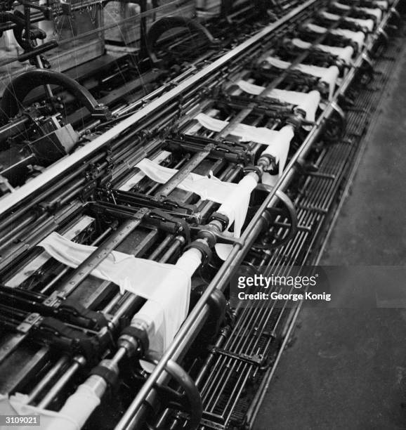 Utility nylon stockings being knitted on a production line at the Ballite Hosiery Mills, St Albans.
