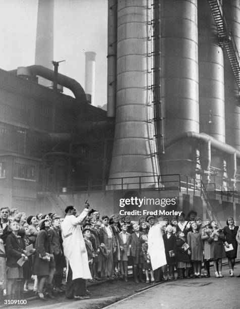 Striking schoolchildren from a school in Romford visit the motor car works at Dagenham accompanied by Councillor Fruitnight.