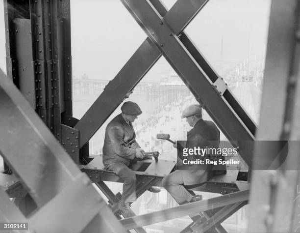 Two men working on a girder in Blackpool Tower.