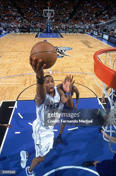 Tracy McGrady of the Orlando Magic lays the ball up during the game against the Washington Wizards at the TD Waterhouse Centre on March 10, 2004 in...