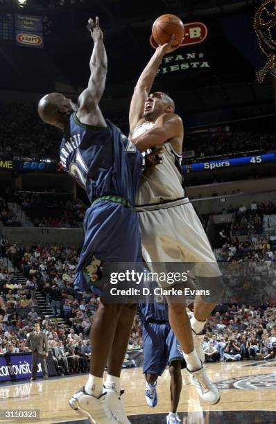 Tim Duncan of the San Antonio Spurs shoots over Kevin Garnett of the Minnesota Timberwolves during the game at the SBC Center on March 18, 2004 in...