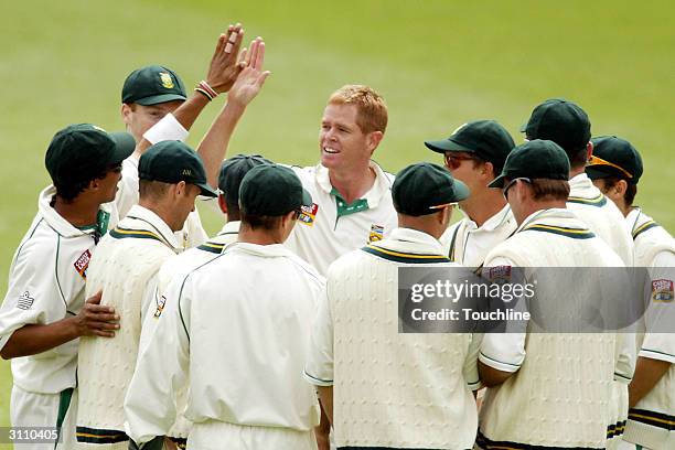 Shaun Pollock of South Africa celebrates with teammates after he broke Allan Donalds' record of 331 wickets during the second day of the 2nd Test...