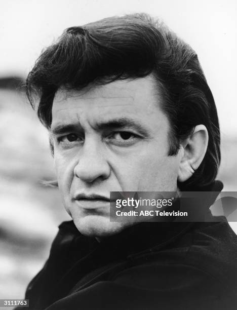 Promotional headshot portrait of American country singer and songwriter Johnny Cash , for his television variety show, 'The Johnny Cash Show,' circa...