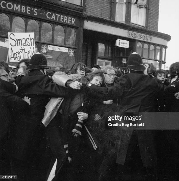 Police controlling an anti-apartheid demonstration outside a rugby ground where Midland Counties are meeting the Springboks.