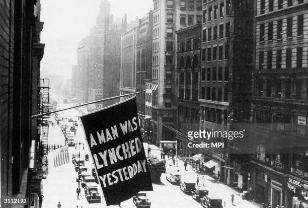 Flag hanging outside the headquarters of the NAACP at 69 Fifth Avenue, New York City, bearing the words 'A Man was Lynched Yesterday'.