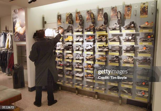 Shopper looks at shoes inside a Niketown store March 19, 2004 in Chicago, illinois. Nike Inc. Reported a 60 percent rise in third quarter net income...