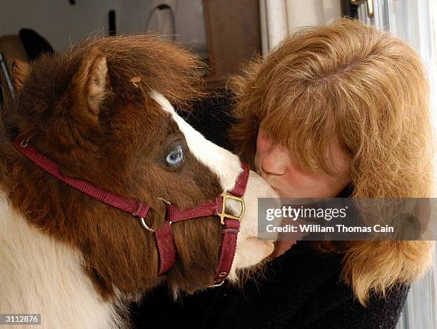 Shari Bernstiel kisses Tonto, her guide horse, on the nose while they prepare to take a walk March 19, 2004 in Lansdale, Pennsylvania. Tonto, a...