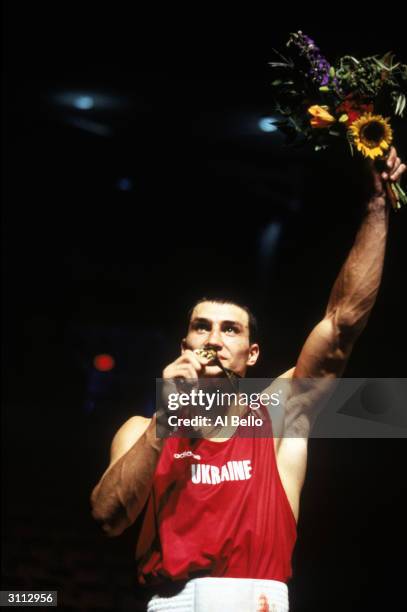 Vladimir Klitschko of the Ukraine celebrates his Gold Medal win against Paea Wolfgram of Tongo in the 91kg final during the XXVI Olympic Games at...