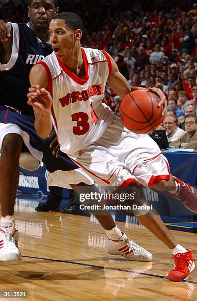 Guard Devin Harris of the Wisconsin Badgers drives past a Richmond Spiders defender during the first round game of the NCAA Division I Men's...