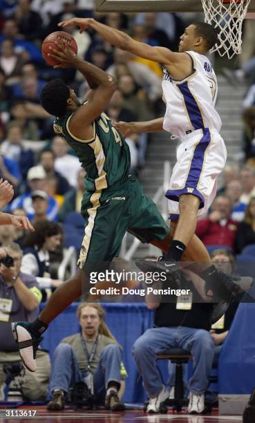 Gabe Kennedy of the UAB Blazers is fouled by Brandon Roy of the Washington Huskies during the first round game of the NCAA Division I Men's...