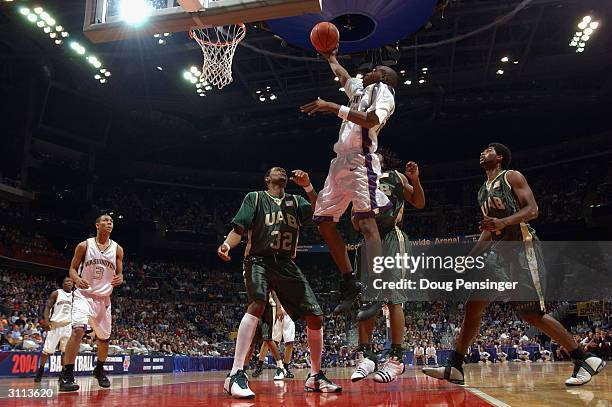 Curtis Allen of the Washington Huskies lays the ball up over Sidney Ball of the UAB Blazers during the first round game of the NCAA Division I Men's...