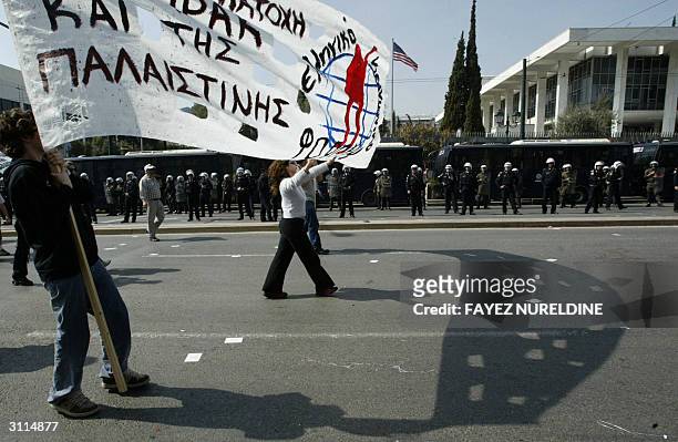 Greek protesters hold a banner reading "Victory for Palestine as they march in front of the US embassy during an anti-US war in Iraq to mark the one...