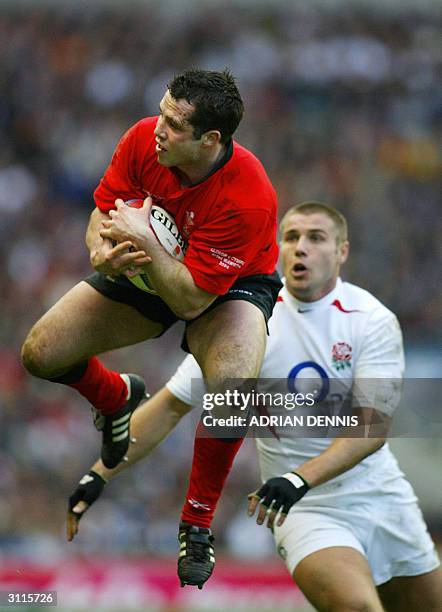 Gareth Cooper of Wales takes a catch as England's Ben Cohen closes in during the Six Nations match at Twickenham, west London 20 March 2004. England...