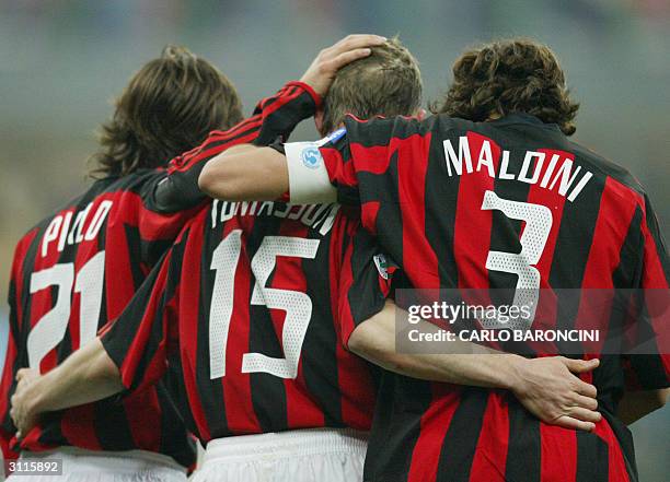 Milan's Jon Dahl Tomasson celebrates with his teammates Andrea Pirlo and captain Paolo Maldini after scoring against Parma during a Series A l match...