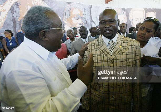 Haitian Prime Minister Gerard Latortue talks with rebel leader Buteur Meteye 20 March 2004 in Gonaives, Haiti. Latortue adressed a crowd of some two...