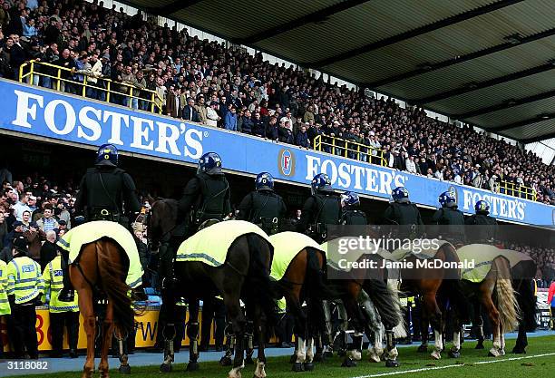 Police Horses hold back the West Ham fans during the Nationwide Division One match between Millwall and West Ham United at The New Den on March 21,...