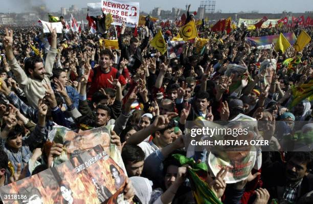 Kurdish people hold posters of the imprisoned Kurdish rebel leader Abdullah Ocalan during the celebrations of the Kurdish new year festival Newroz in...