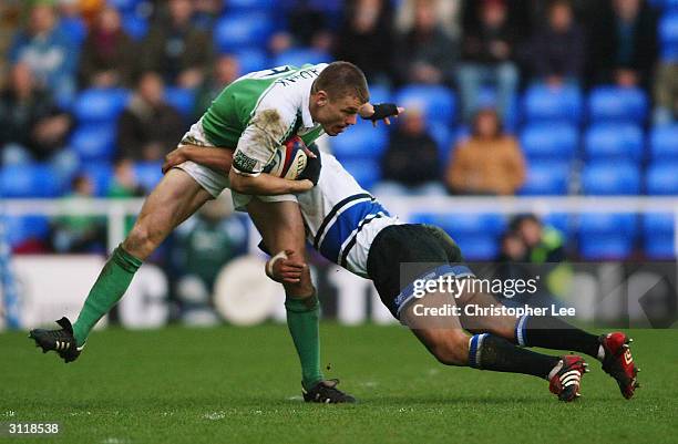 Michael Horak of London Irish is tackled by Wylie Human of Bath during the Zurich Premiership match between London Irish and Bath at the Madejski...
