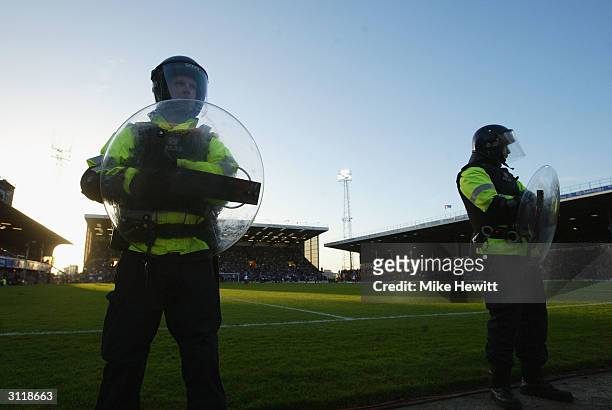 Riot police line the ground during the FA Barclaycard Premiership match between Portsmouth and Southampton at Fratton Park on March 21, 2004 in...