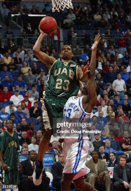 Demario Eddins of the UAB Blazers goes up for a shot over Antwain Barbour of the Kentucky Wildcats as the Blazers upset the Wildcats 76-75 during the...