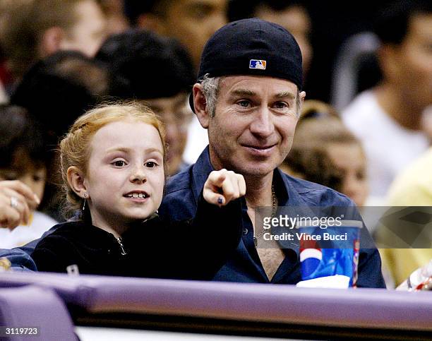 Tennis star John McEnroe and daughter Ava attend the game between the LA Lakers and the Milwalkee Bucks on March 21, 2004 in Los Angeles, California.