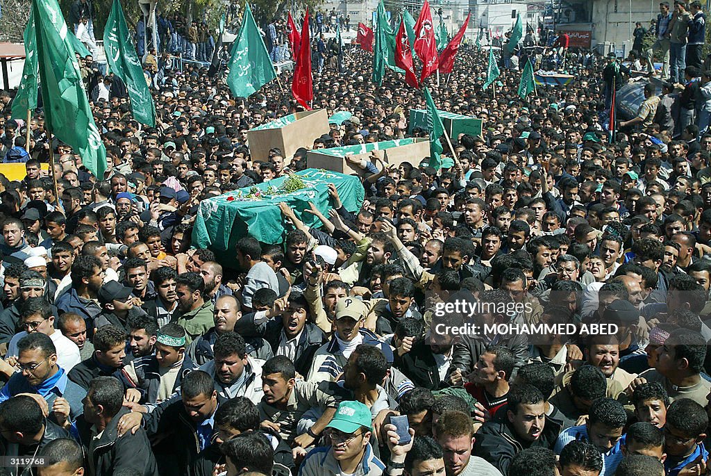 Palestinian mourners carry the coffin of