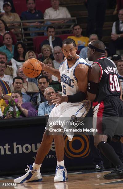 Juwan Howard of the Orlando Magic posts up against Zach Randolph of the Portland Trail Blazers during the game at TD Waterhouse Centre on February...