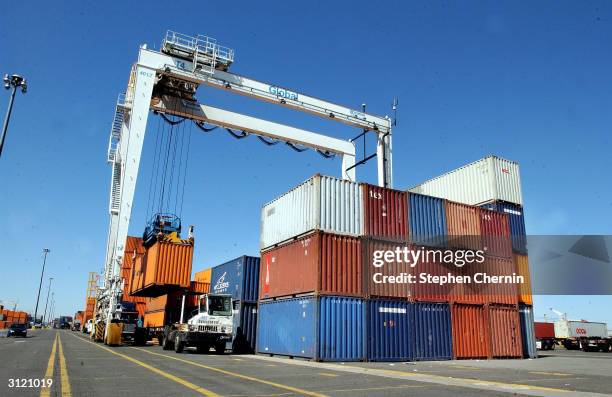 Tractor trailer has it's shipping container lifted for storage and examination at the docks March 22, 2004 in Jersey City, New Jersey. U.S. Customs...