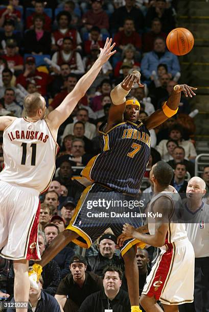 Jermaine O'Neal of the Indiana Pacers passes the ball against Zydrunas Ilgauskas and Dajuan Wagner of the Cleveland Cavaliers during the game at Gund...