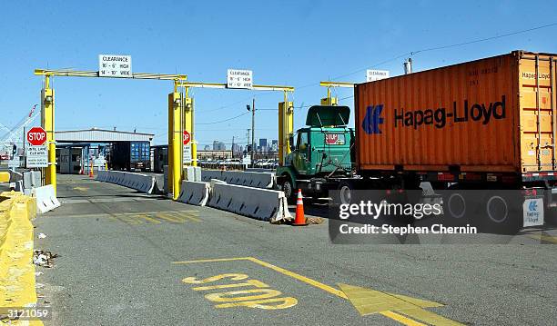 Tractor trailer drives through a radiation portal monitor as it leaves the docks March 22, 2004 in Jersey City, New Jersey. U.S. Customs and Border...