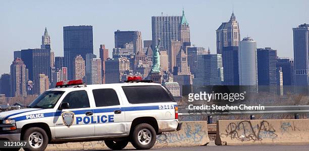 With lower Manhattan in the background, a New York/New Jersey Port Authority police vehicle drives by Global Marine Terminal March 22, 2004 in Jersey...