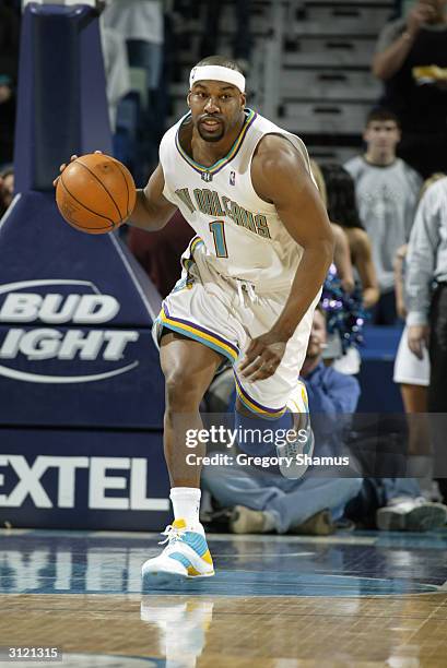 Baron Davis of the New Orleans Hornets brings the ball upcourt during the game against the Miami Heat on March 10, 2004 at New Orleans Arena in New...