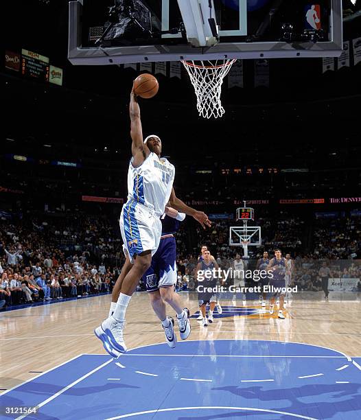 Carmelo Anthony of the Denver Nuggets goes up to dunk the ball during the game against the Utah Jazz at the Pepsi Center on March 14, 2004 in Denver,...