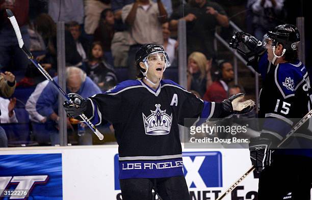 Left winger Luc Robitaille of the Los Angeles Kings celebrates with teammate Jozef Stumpel after he recorded an assist against the Edmonton Oilers on...