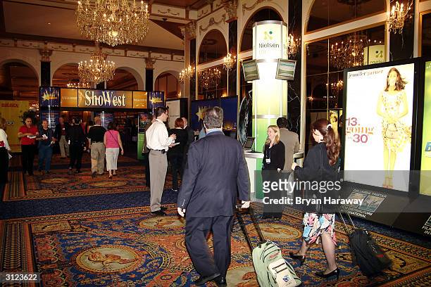 Convention goers march toword the registration booths for the 30th annual ShoWest conference held at the Paris Hotel March 23, 2004 in Las Vegas,...