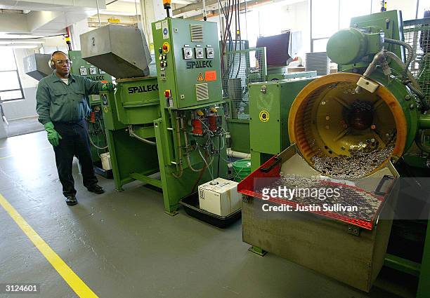 Worker monitors a machine that polishes coin blanks at the U.S. Mint March 23, 2004 in San Francisco, California. The San Francisco Mint opened in...