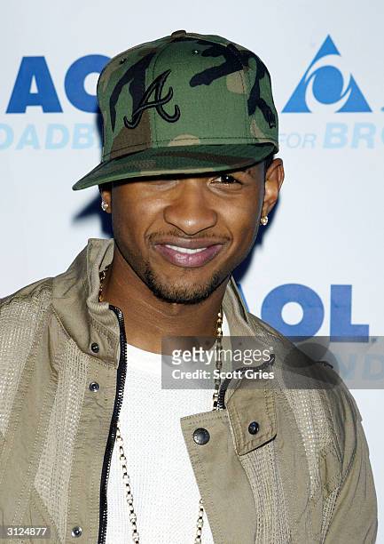 Usher poses for a photo before his performance for AOL to celebrate his new album release "Confessions" at Webster Hall March 23, 2004 in New York...