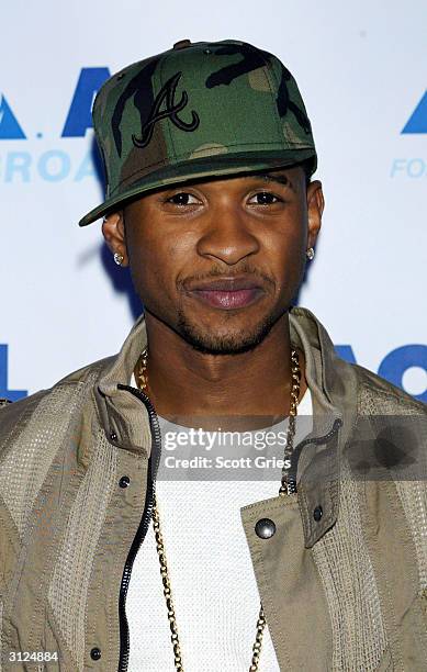 Usher poses for a photo before his performance for AOL to celebrate his new album release "Confessions" at Webster Hall March 23, 2004 in New York...