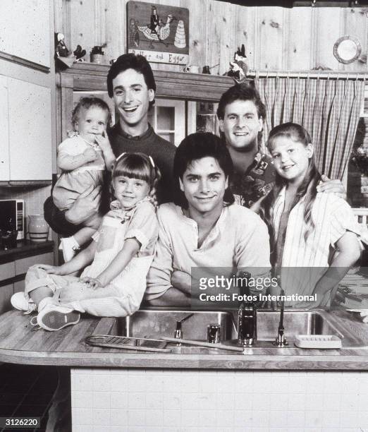Promotional portrait of the cast of the television series, 'Full House,' L-R: Ashley or Mary Kate Olsen, Bob Saget, David Coulier, Candace Cameron,...