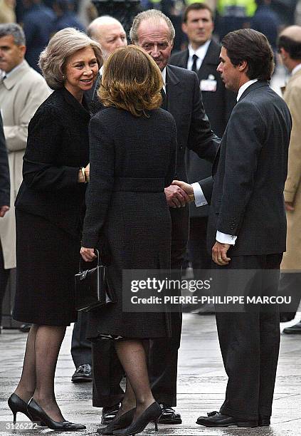 Spain's King Juan Carlos and Queen Sofia greet outgoing Spanish Prime Minister Jose Maria Aznar and wife Ana Botella as they arrive for the memorial...