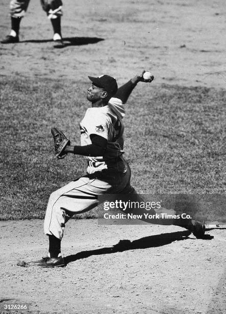 American baseball player Leroy 'Satchel' Paige delivers a pitch on
