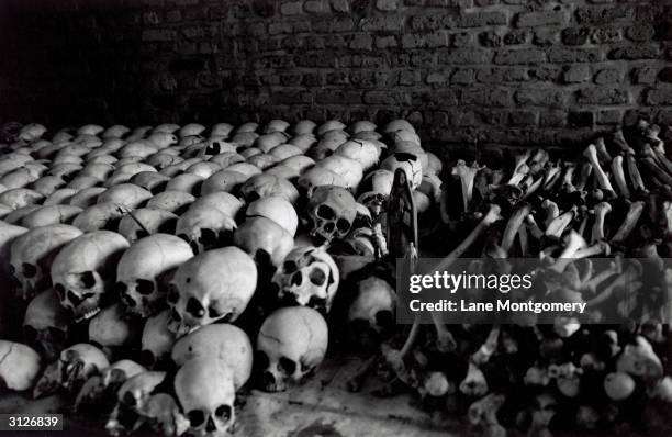 Row of human skulls and remains cover the interior of the Ntarama church which was destroyed during the genocide in Rwanda, Kigali, circa 1994.