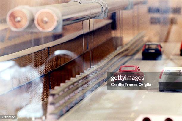 Plastic wind gallery of the planned bridge over the Strait of Messina, designed by Pininfarina, is shown with small toy vehicles March 24, 2004 in...