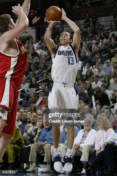 Steve Nash of the Dallas Mavericks shoots over Bob Sura of the Atlanta Hawks during the game at American Airlines Arena on March 17, 2004 in Dallas,...
