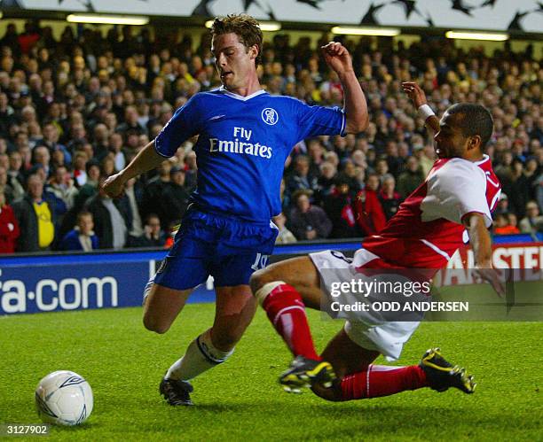 Arsenal's Ashley Cole tackles Chelsea's Scott Parker during their Champions League quarter-final football match 24 March, 2004 at Stamford Bridge,...