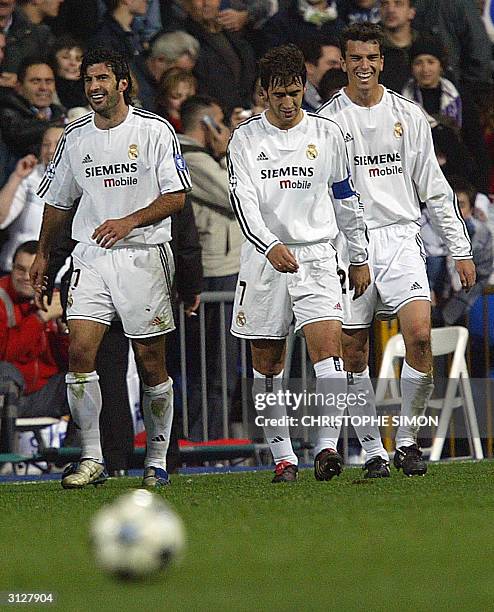 Real Madrid's player Portuguese midfielder Luis Figo, Spanish forward Raul Gonzalez and Spanish defender Francisco Pavon react after a goal during...