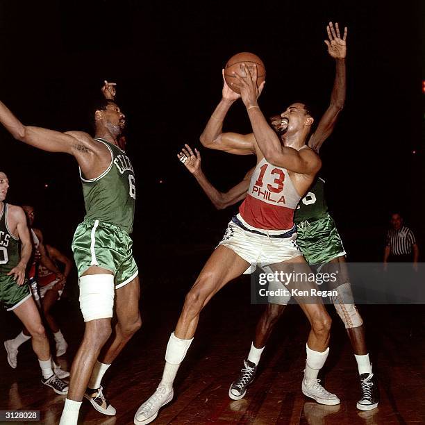 Wilt Chamberlain of the Philadelphia 76ers grabs a rebound against the Boston Celtics during the NBA game circa 1965 in Philadelphia, Pennsylvania....