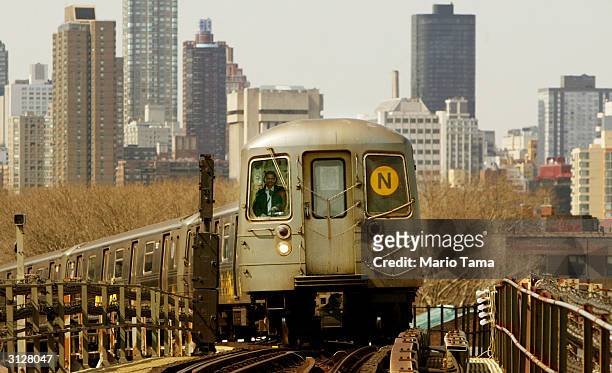 Subway train travels above ground with the Manhattan skyline in the background March 24, 2004 in New York City. The New York subway system is...