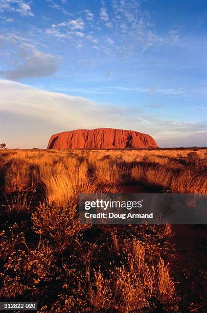 australia,northern territories, ayers rock on horizon at dusk - uluru stock pictures, royalty-free photos & images